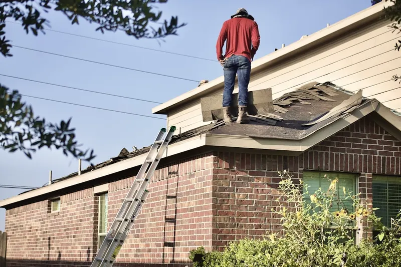 Professional roofer working on a residential roof in Chimney Ridge